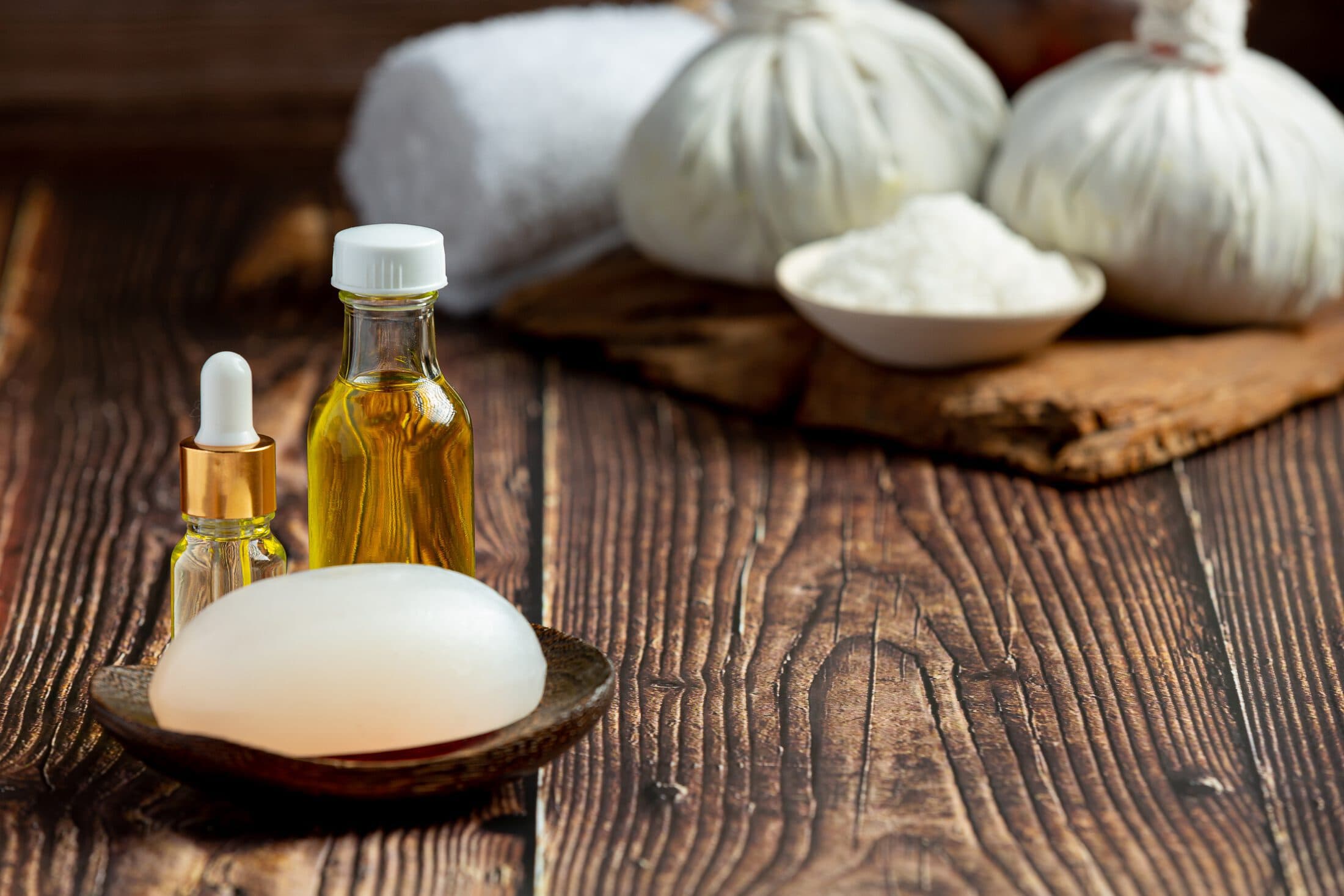 Herbal spa treatment equipment arranged on a wooden floor
