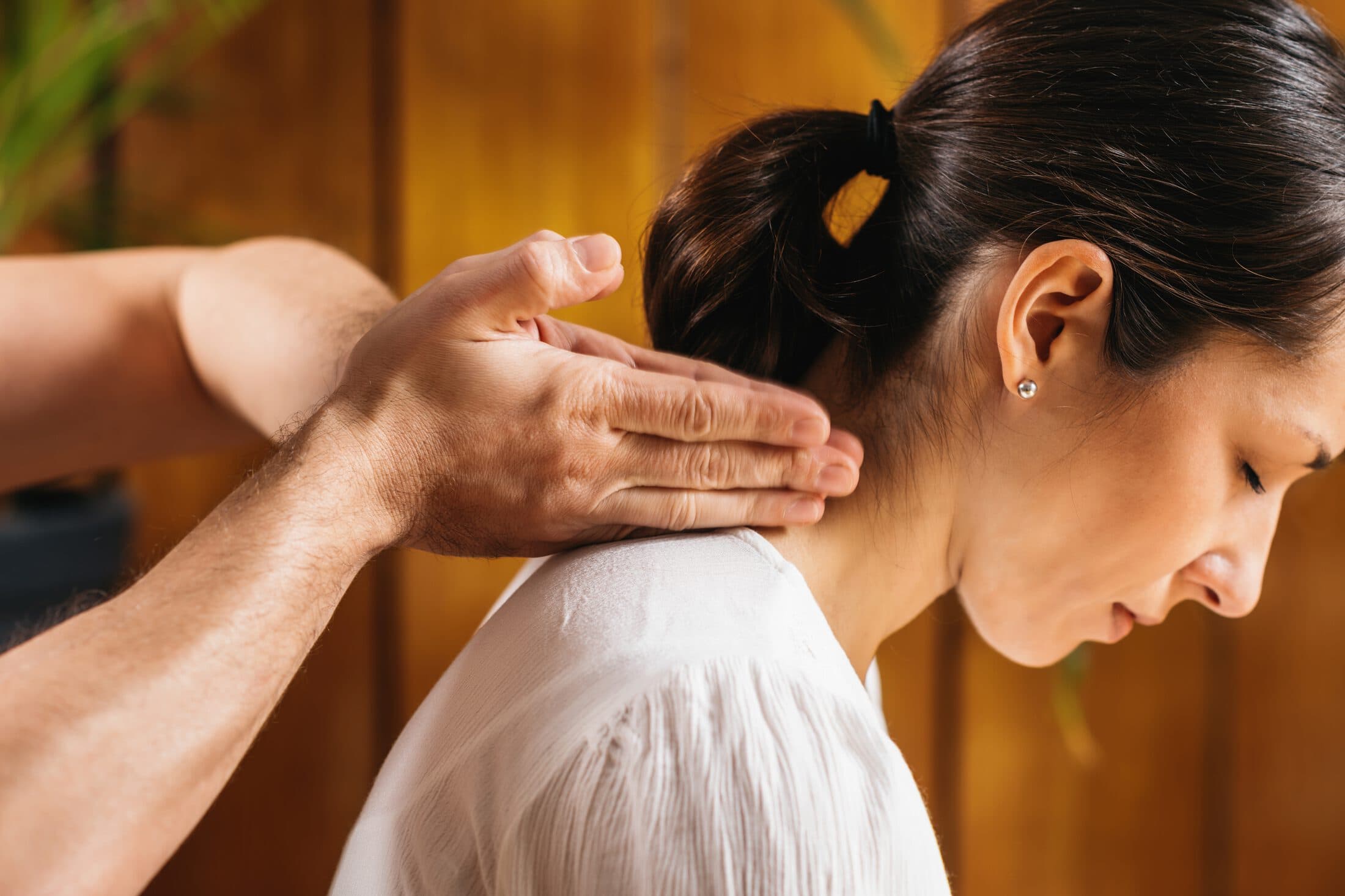 Thai practitioner applying traditional upper-body treatment techniques